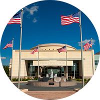 American flags fly over the entrance of the George H.W. Bush Presidential Library and Museum.