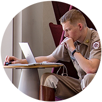 Aggie Corps student studies on a computer.